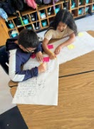 two students work together on a math problem