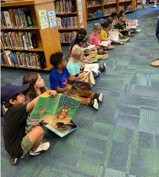 Students reading books in library