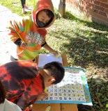 students solving math problem in the garden